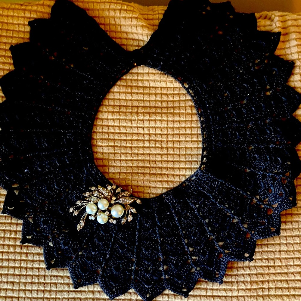 Brooch and black collar.